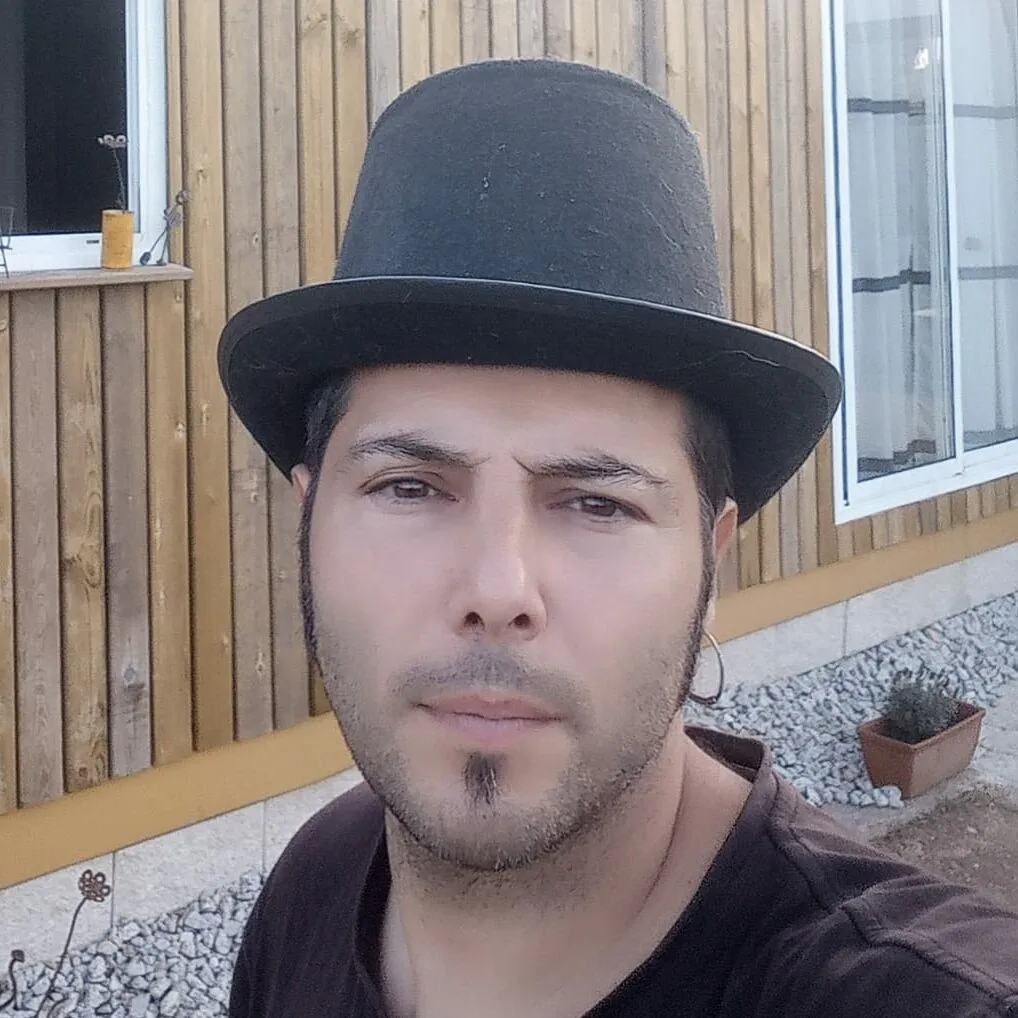 Charlie, cunha chisteira negra, diante da parede de madeira da casa